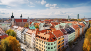 Das Bild zeigt eine belebte Skyline von München mit hohen Gebäuden und geschäftigen Straßen. Im Vordergrund gibt es Reihen von bunten Gebäuden mit einer Mischung aus moderner und traditioneller Architektur. Die Stadt bietet eine Vielzahl von Wohnmöglichkeiten zur Miete oder zum Kauf, und es gibt beliebte Stadtteile wie Schwabing, Haidhausen und Neuperlach, die jeweils ihre einzigartigen Vorteile bieten.